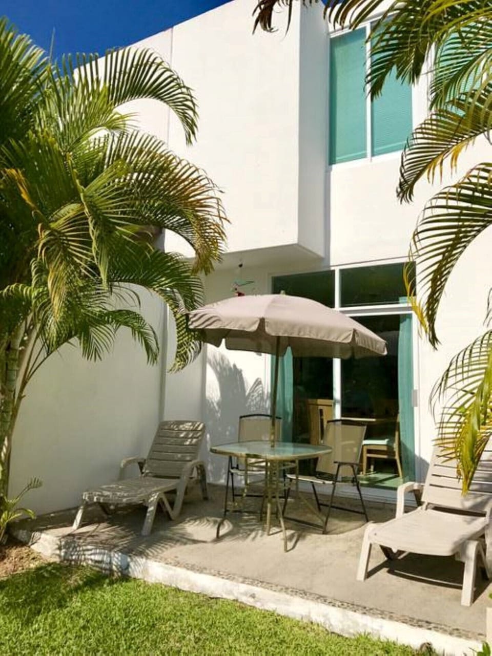 Back patio next to gardens, palapa and swimming pool
