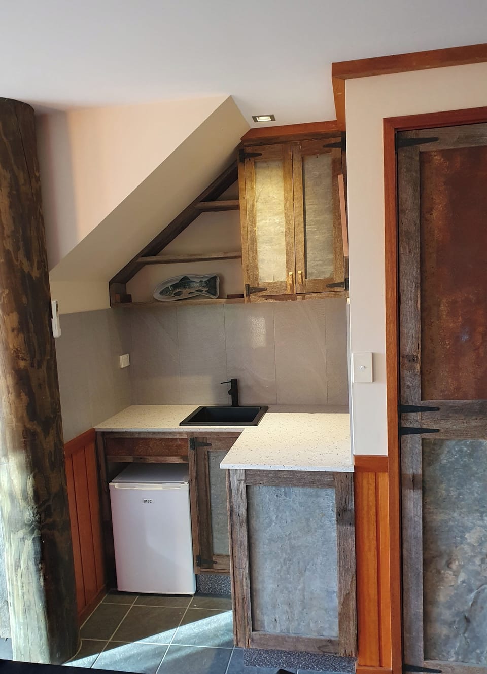 A small bar area is also featured in the second entertaining area