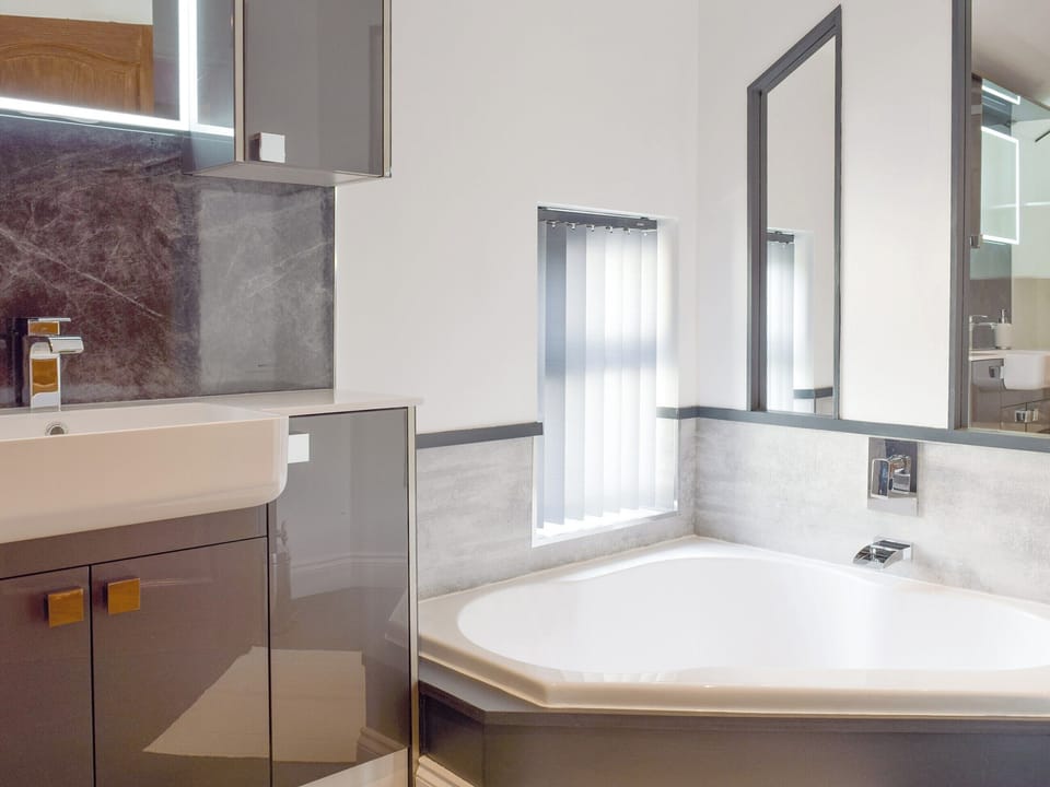 Bathroom with corner bath and separate shower enclosure | Brynhowell - Brynhowell Barns, Glandwr, near Narbeth