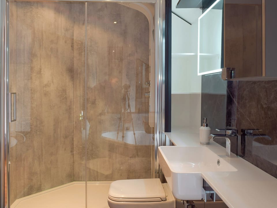 Bathroom with corner bath and separate shower enclosure | Brynhowell - Brynhowell Barns, Glandwr, near Narbeth