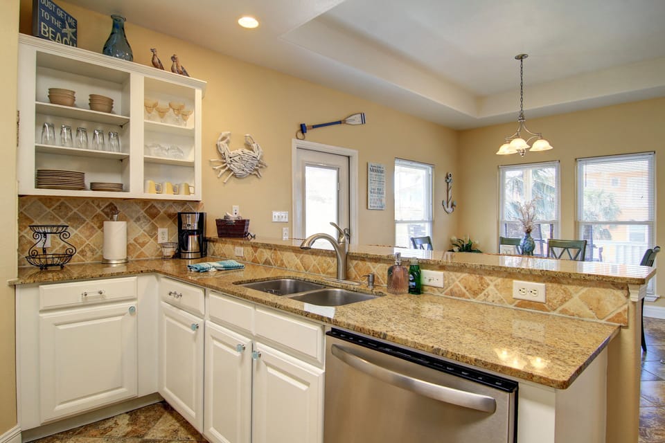 The kitchen is fully stocked with cookware, utensils, coffee pot, toaster, etc.