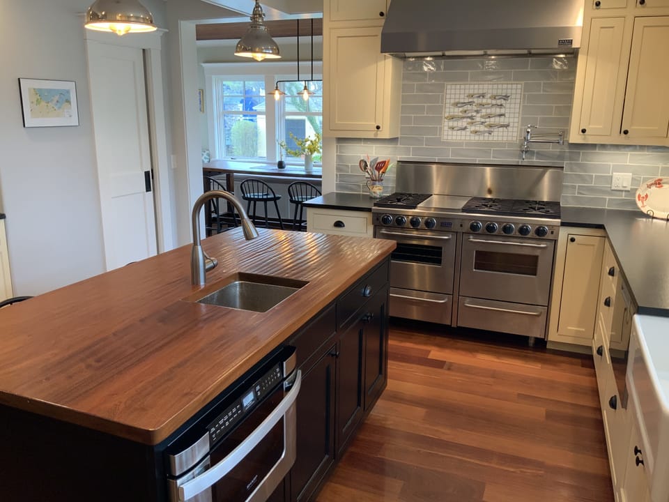 Kitchen view with dining area in the background