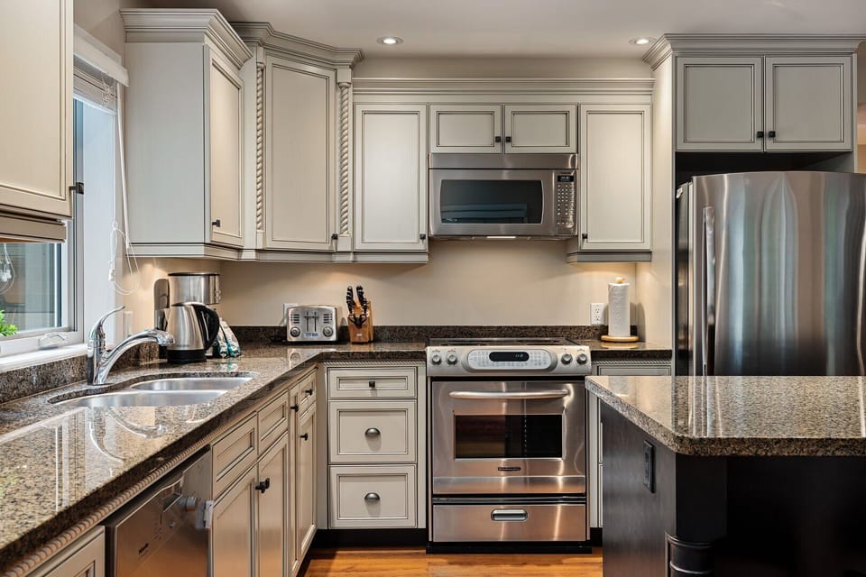 Gourmet kitchen with modern appliances and center island with breakfast bar