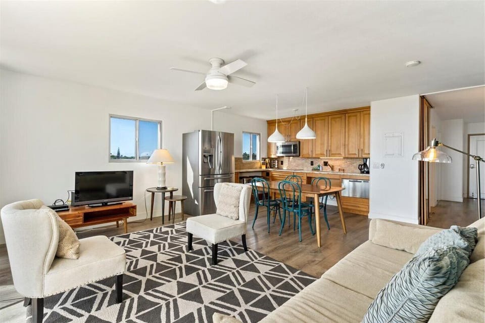 Open living room with open plan kitchen and dining.