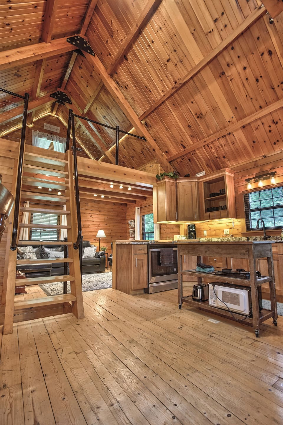 This open floor plan allows for extra space for the whole family between the kitchen and living area. This beautiful and unique staircase leads to the upstairs loft!