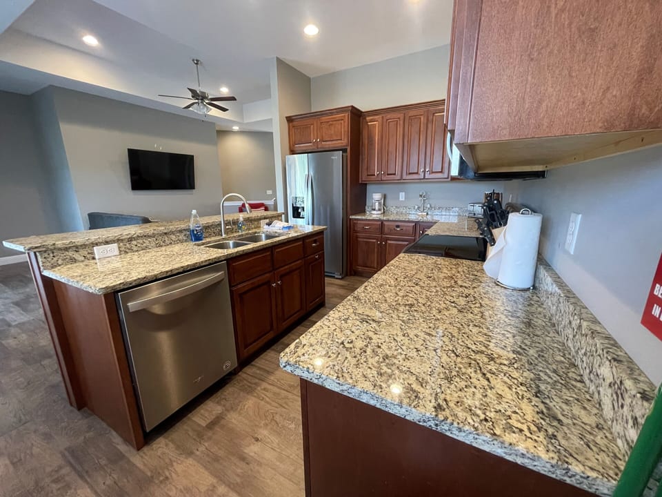 Kitchen has stove and dishwasher. Sink has disposal