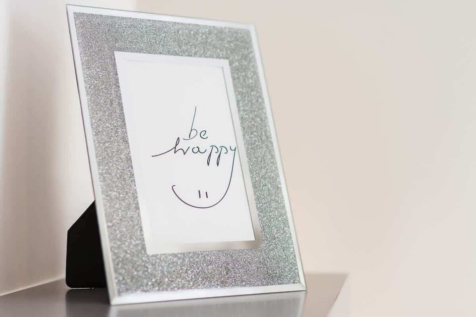 A framed decorative piece with an inspirational quote, adding a personalized touch to the living area.