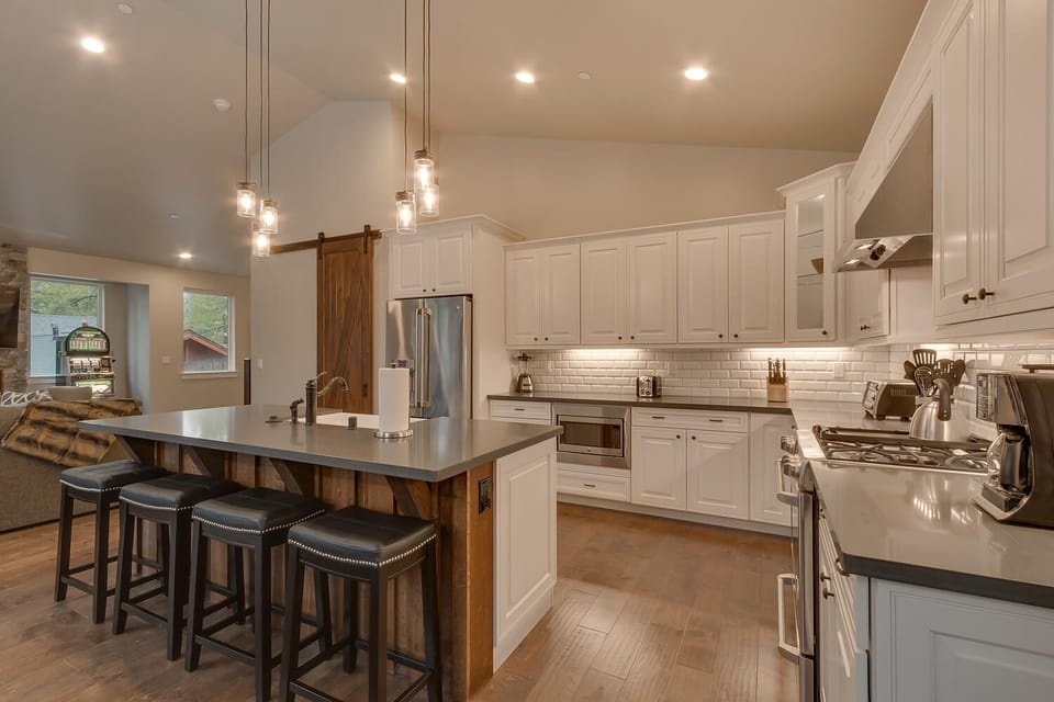 - Stylish kitchen with bar seating  
- Subway tile backsplash and storage  
- Tahoe Airbnb with modern amenities