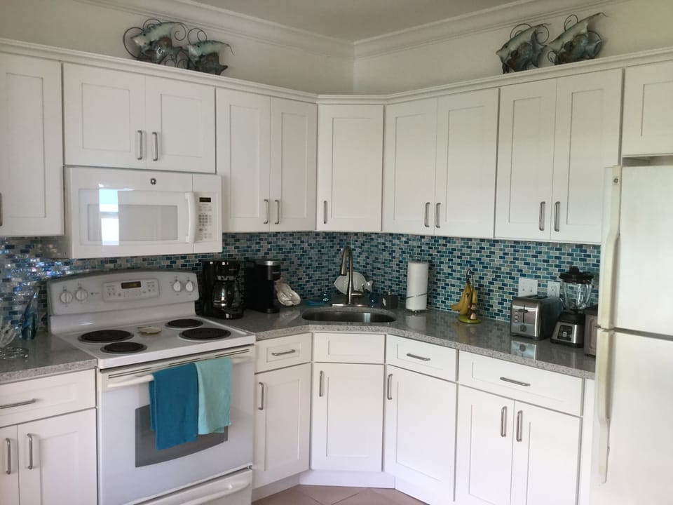 Kitchen with two coffee machines and appliances