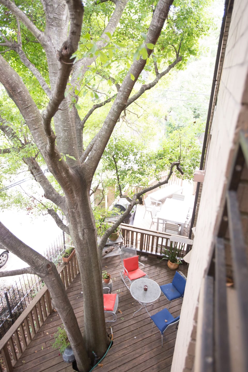 Looking down to outside patio from guest room balcony