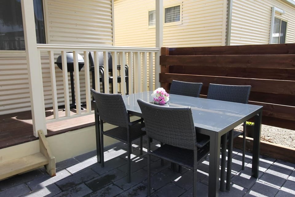 Outdoor table and chairs. Small BBQ.