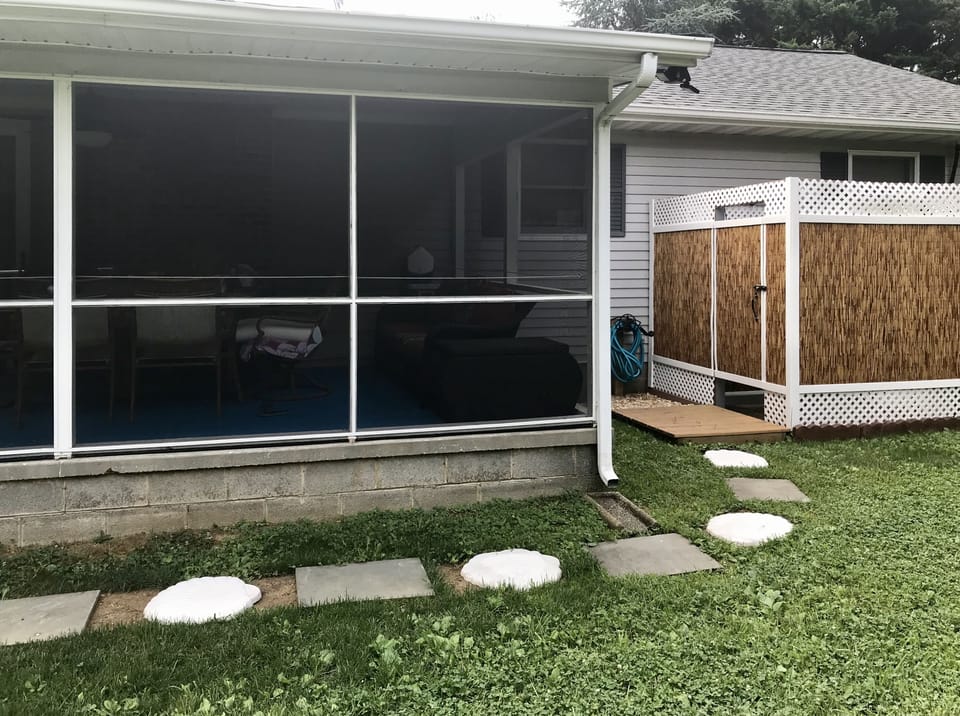 large outdoor shower with dressing area.