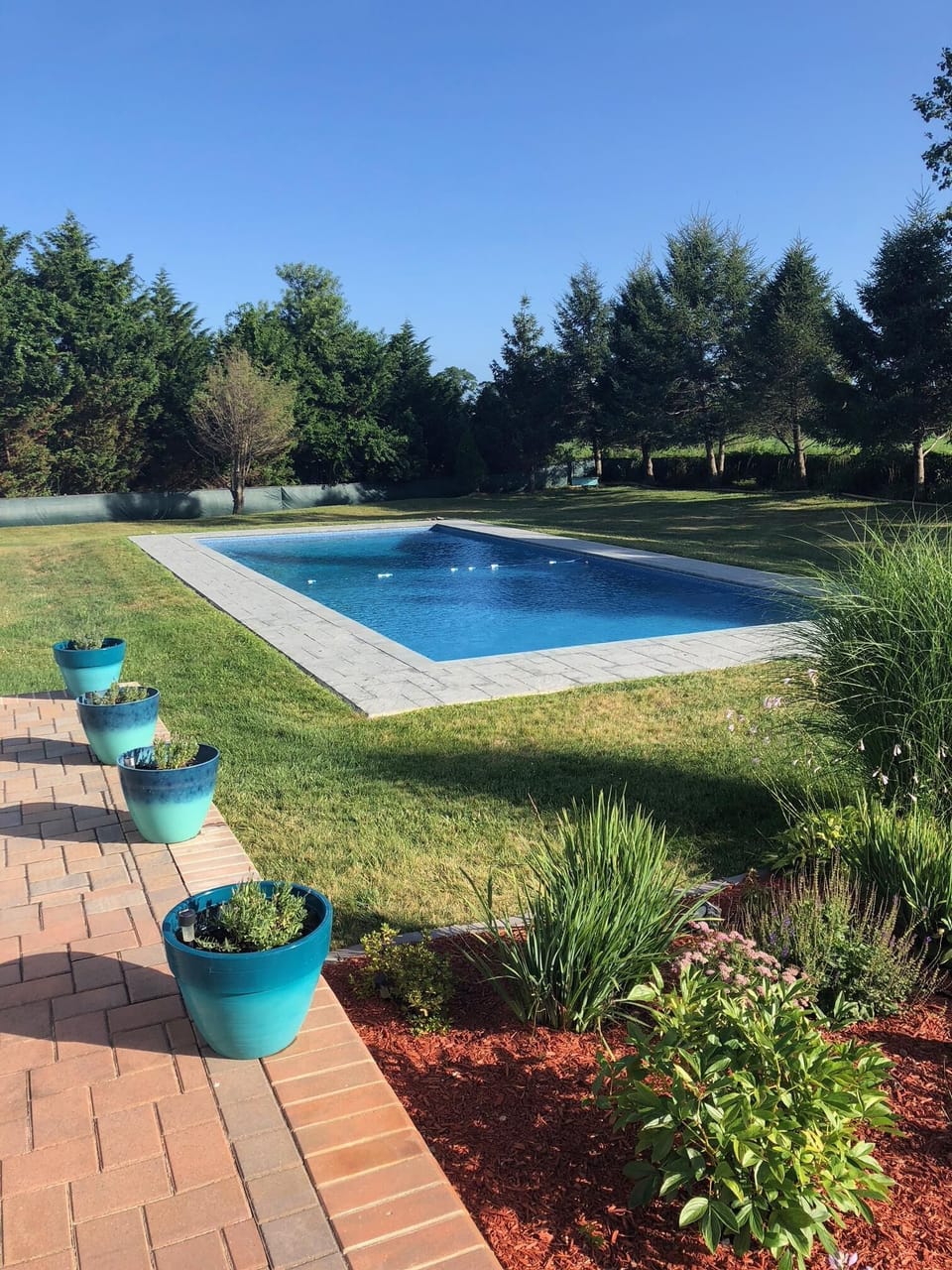 South facing 48 x 20 pool; walk in steps at shallow end, "porch" seat, deep-end 