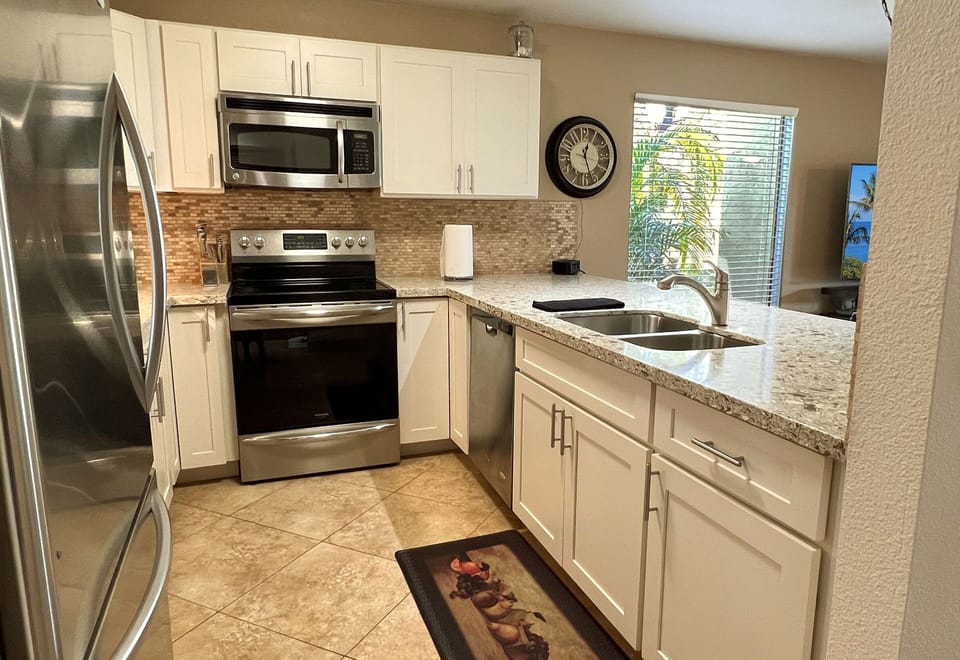 Well stocked kitchen includes dishwasher, full frig & huge counter