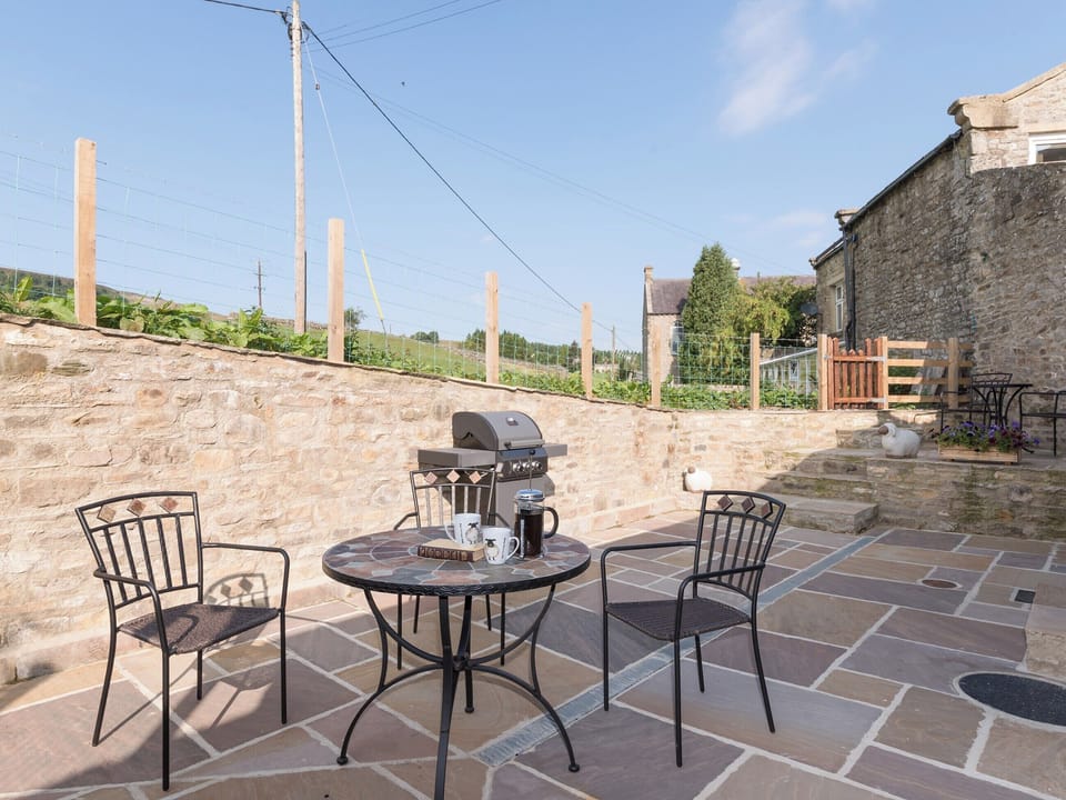 Enclosed courtyard with outdoor furniture and BBQ | Abraham&rsquo;s Cottage, Langthwaite, near Richmond