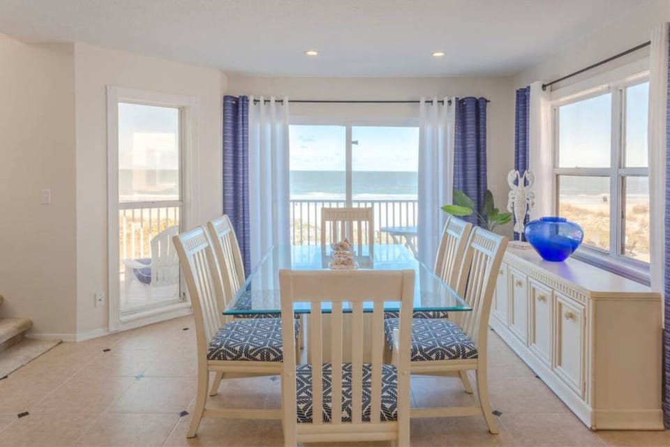 The dining room offers panoramic views of the Gulf. Step out onto the deck to ha