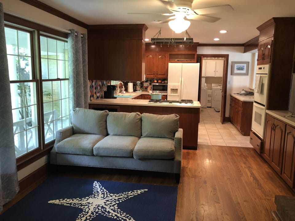 Front living room.  From front hallway and into kitchen.