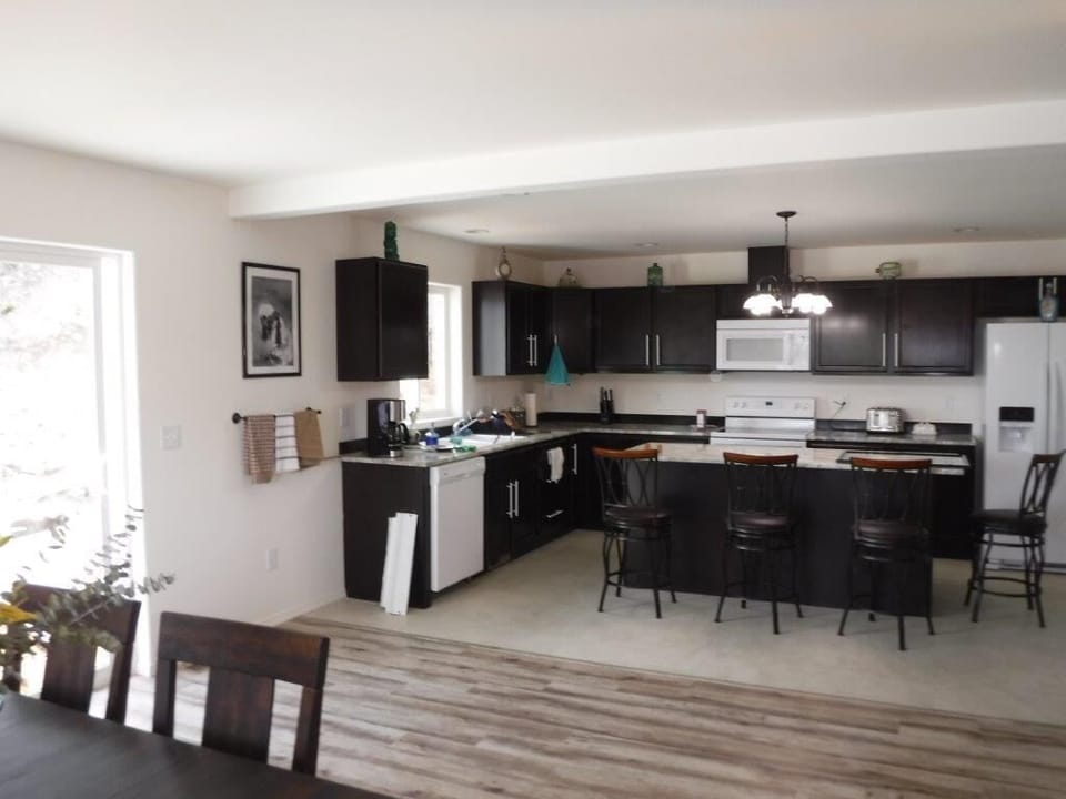 Large open kitchen / dining area by door to the gardens and deck.