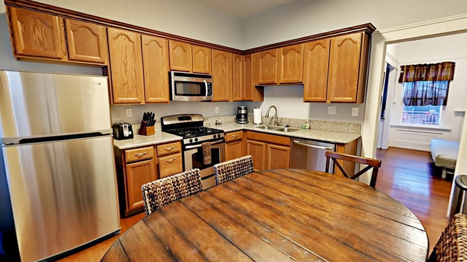 Full Kitchen with Stainless Steel Appliances and Wooden Features