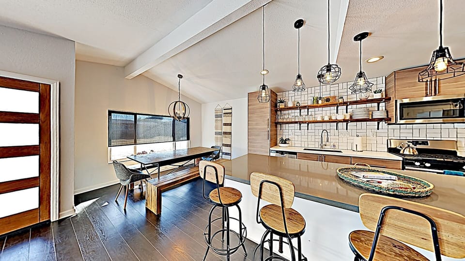 Open Concept New Kitchen counters, cabinets and appliances, island with bar stools for 4 & large dining table that seats up to 10 people.