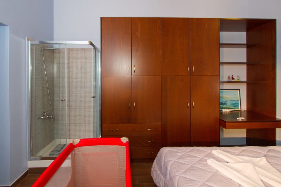 third bedroom with two single beds and a shower