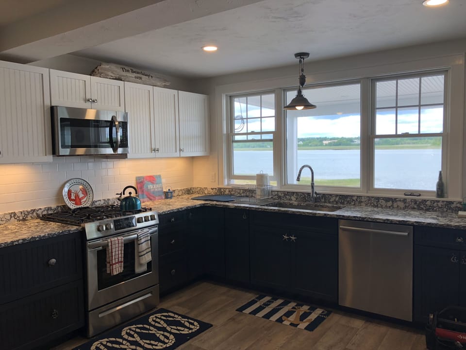 Fully stocked 1st floor kitchen with stainless steel appliances and water views
