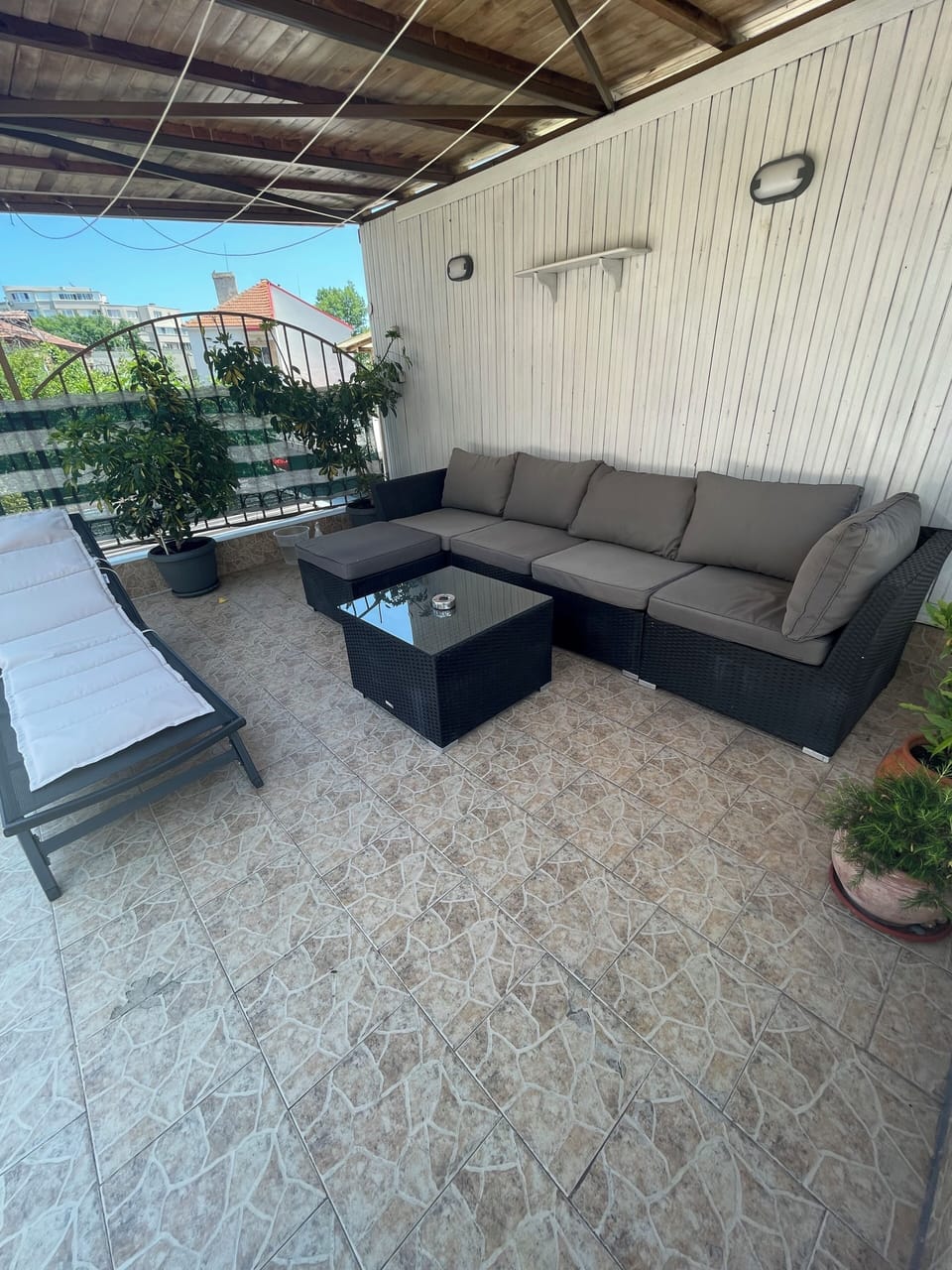 Studio terrace, sun bed, and sitting area.