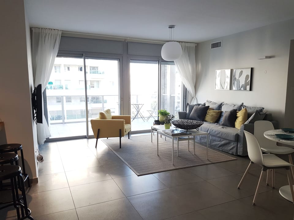  Living room and balcony- Both curtains and electric blinds in most windows