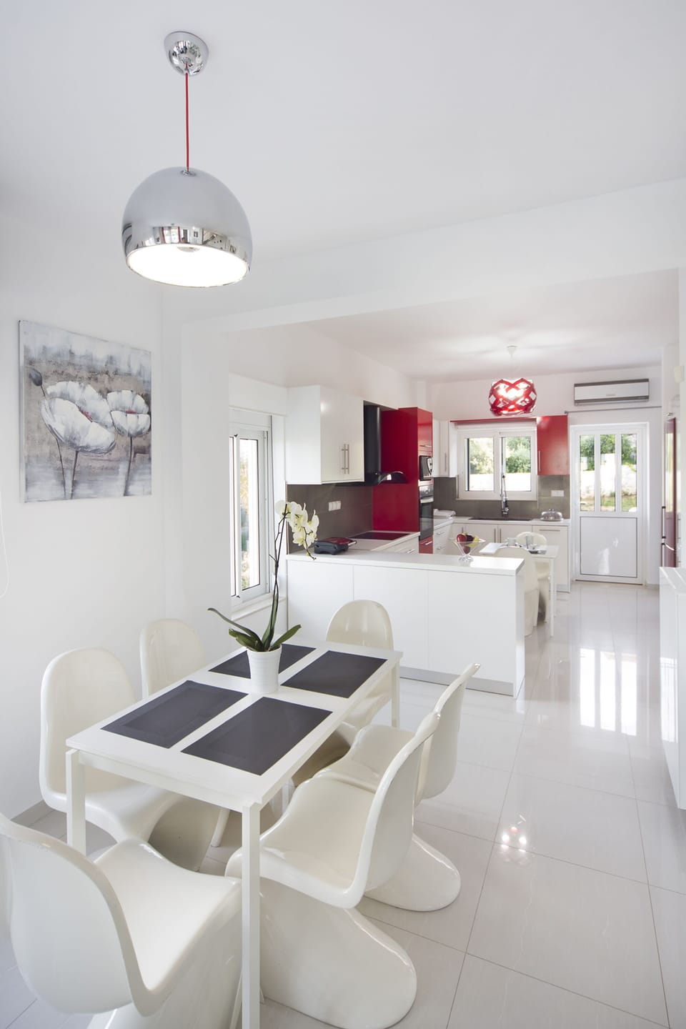 One of the dining tables and the kitchenette in the background