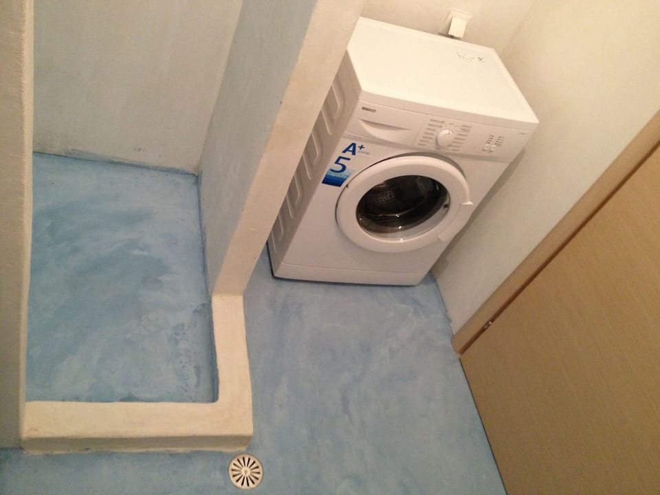 Bathroom with shower and washing machine
