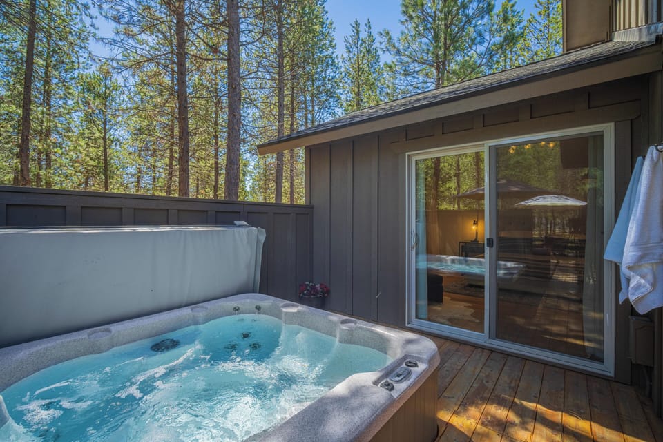 Unwind in the illuminated hot tub surrounded by natural rock features, then take a dip in the adjacent pool—all under dramatic timber beams and bright skylights.