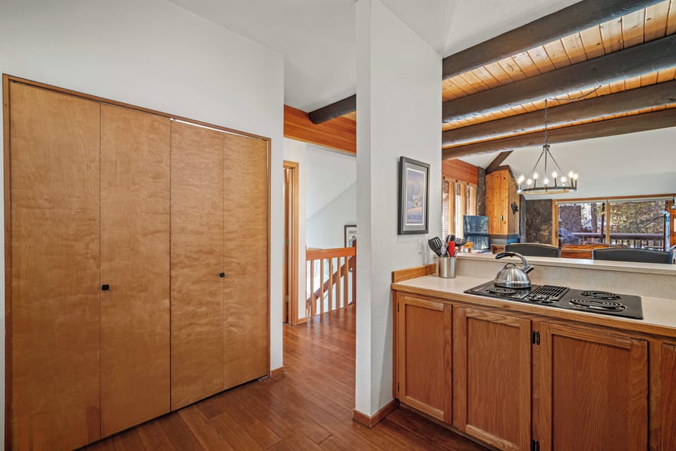 Prepare your favorite meals in this beautifully appointed kitchen featuring exposed wood beams and warm hardwood floors throughout.