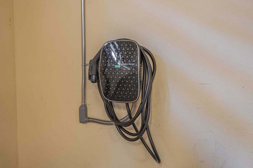 Convenient electric vehicle charging station ready for your eco-friendly travels, ensuring your car stays powered throughout your stay.
