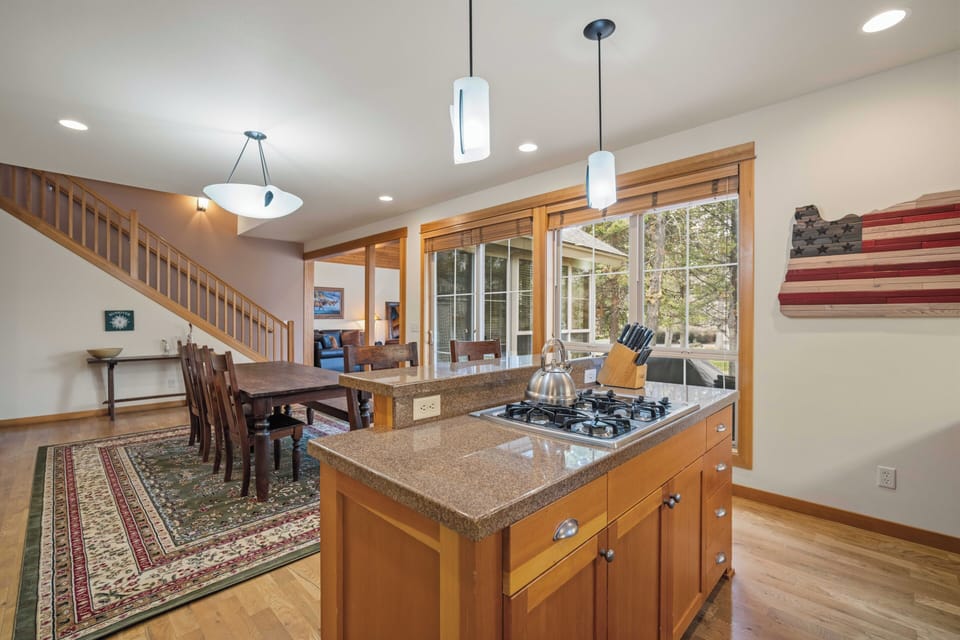 Step into your spacious open kitchen where granite counters and gas cooking invite culinary adventures, while natural light streams through to the dining area.