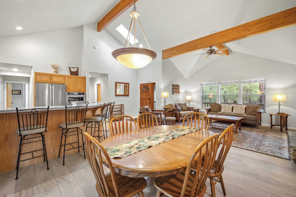 Gather around your spacious dining table while savoring mountain views through expansive windows in this warm, beam-accented great room.