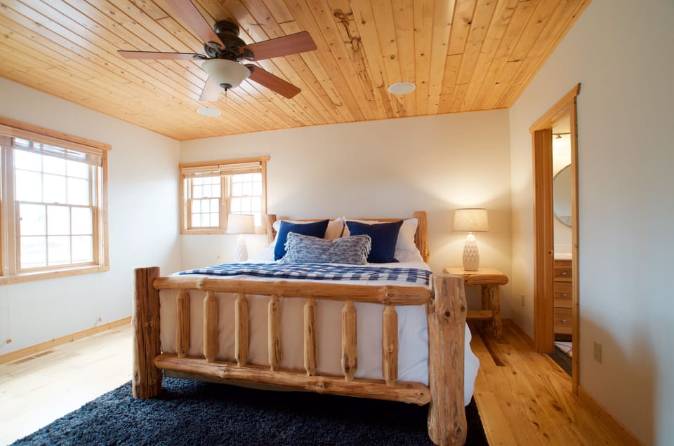 Master bedroom with king size bed and attached full bathroom.