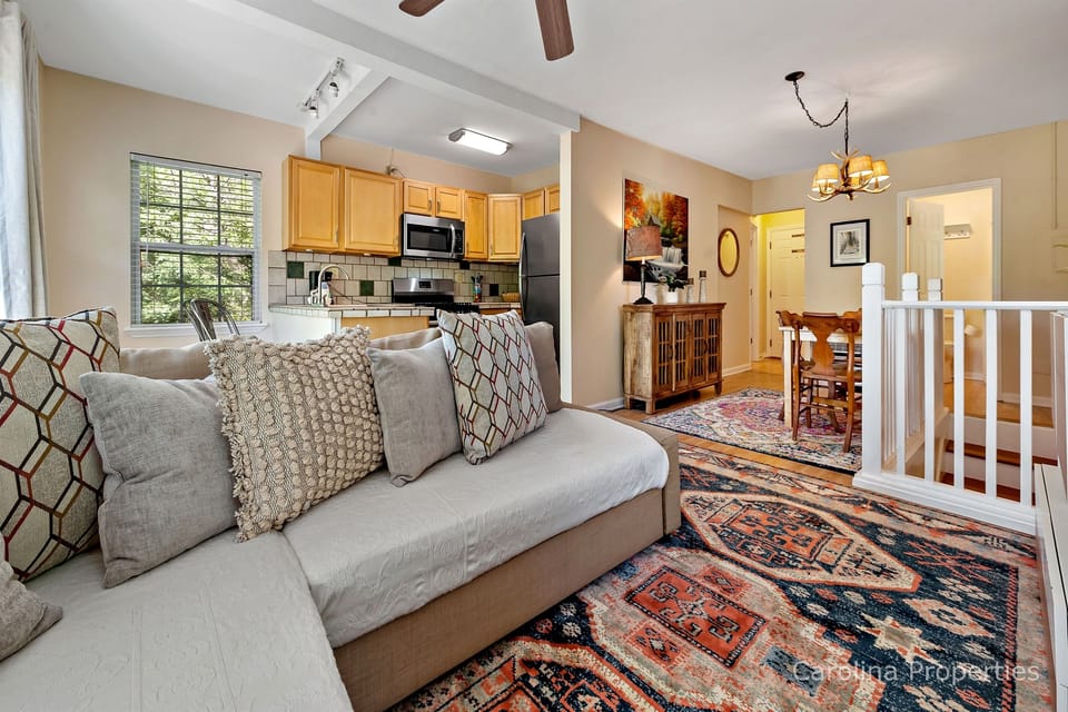 The open living spaces include the kitchen, living room and dining area