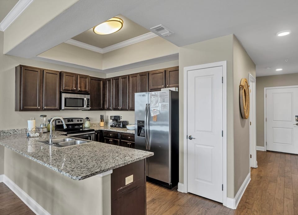 From our kitchen enjoy meal prepping on large expansive granite counter tops w/ views of the ocean sparkling through the window. Pantry provides storage for you food and in-door ice & water di