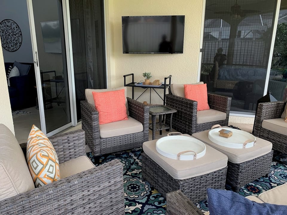 Outdoor living area w/TV and ample seating to relax & enjoy the FL weather