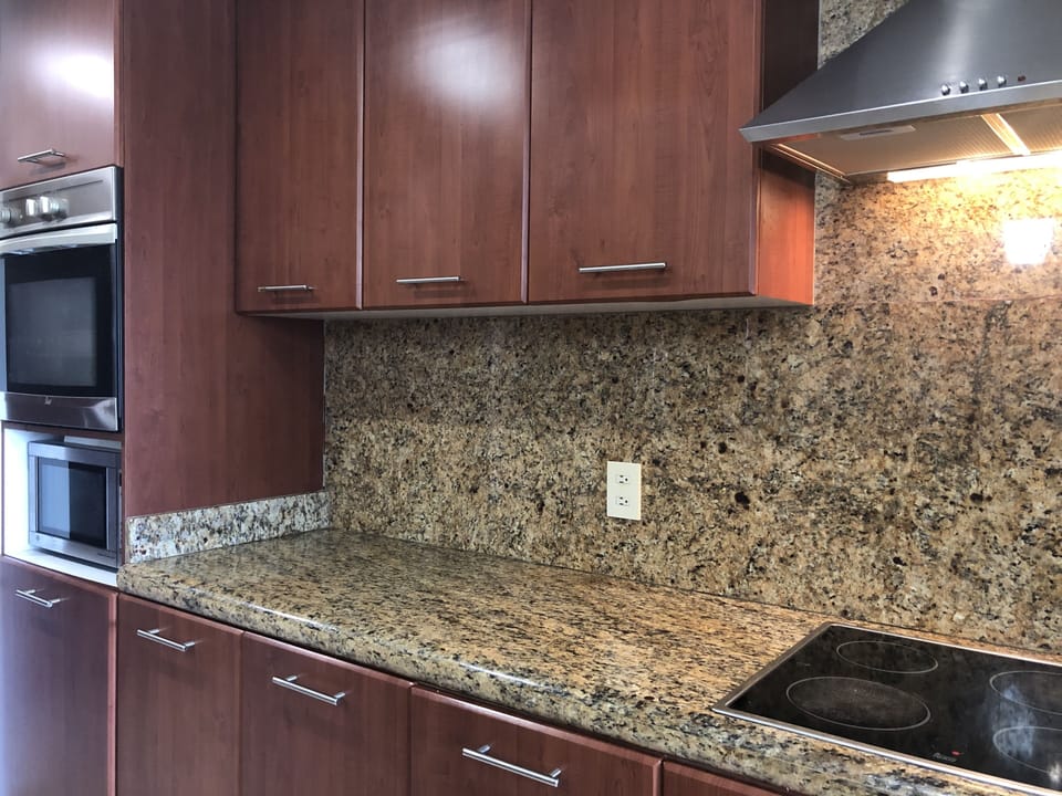 full service kitchen with marble counter tops 