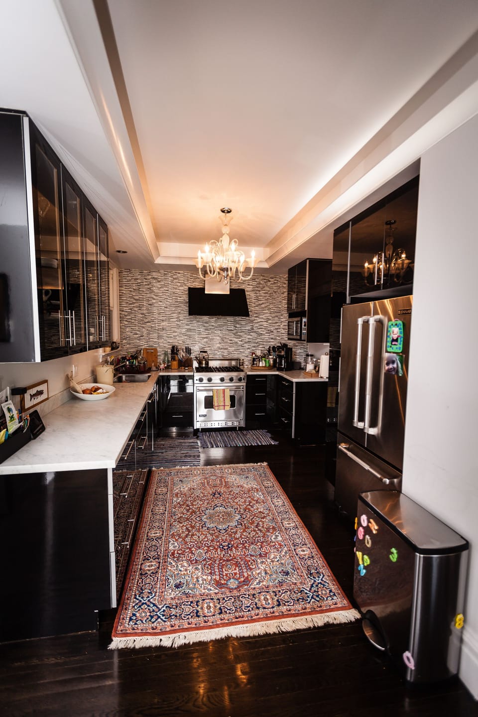 Open kitchen with Carrera marble, Viking range, and Jenn-air refrigerator.