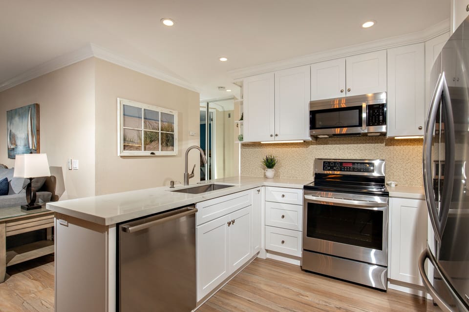 The kitchen is equipped with dishes, pots and pans,  and cooking utensils, blender, coffee pot, and toaster.
