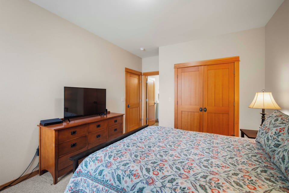 Climb the beautifully crafted wooden staircase to your private upper level, where cozy carpeted hallways lead to peaceful bedrooms.