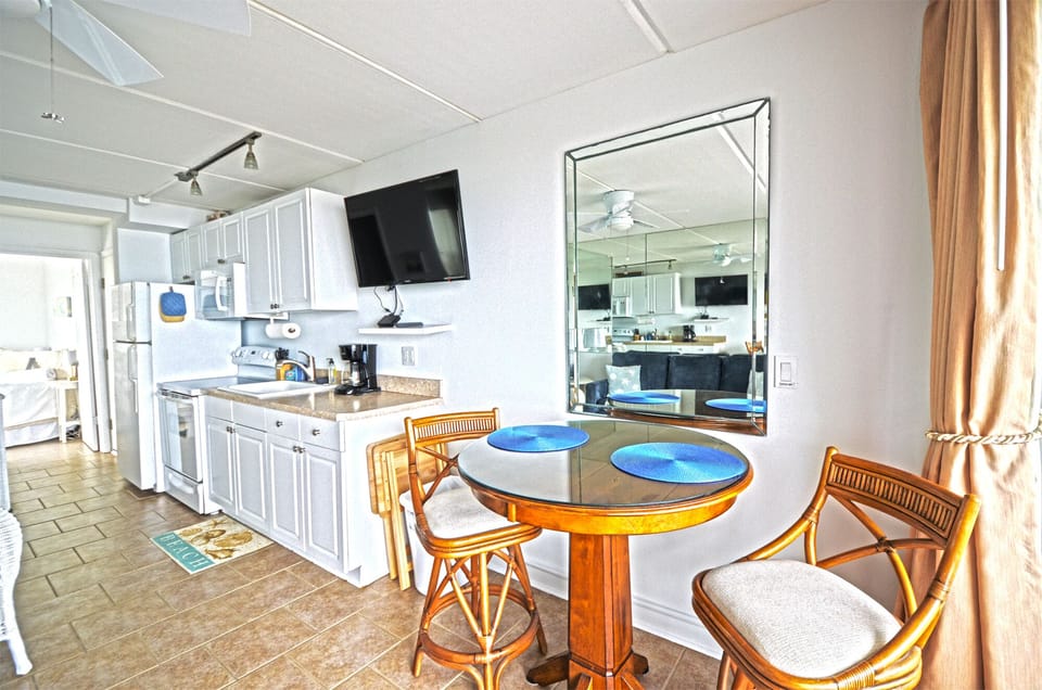 High-top dining table seats 2 next to the fully-stocked kitchen.