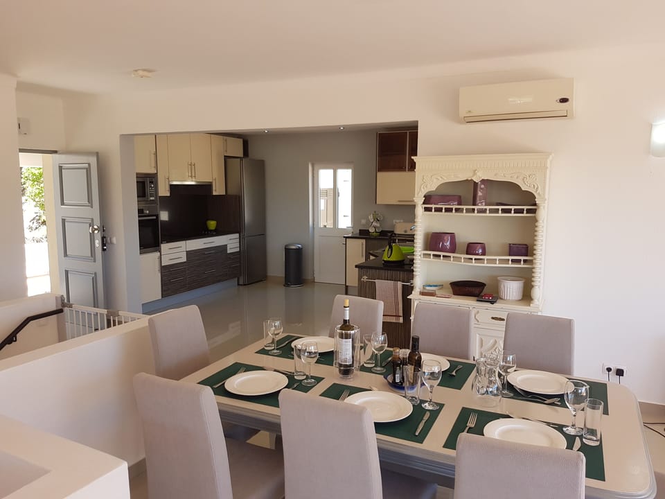 The dining area with kitchen beyond.