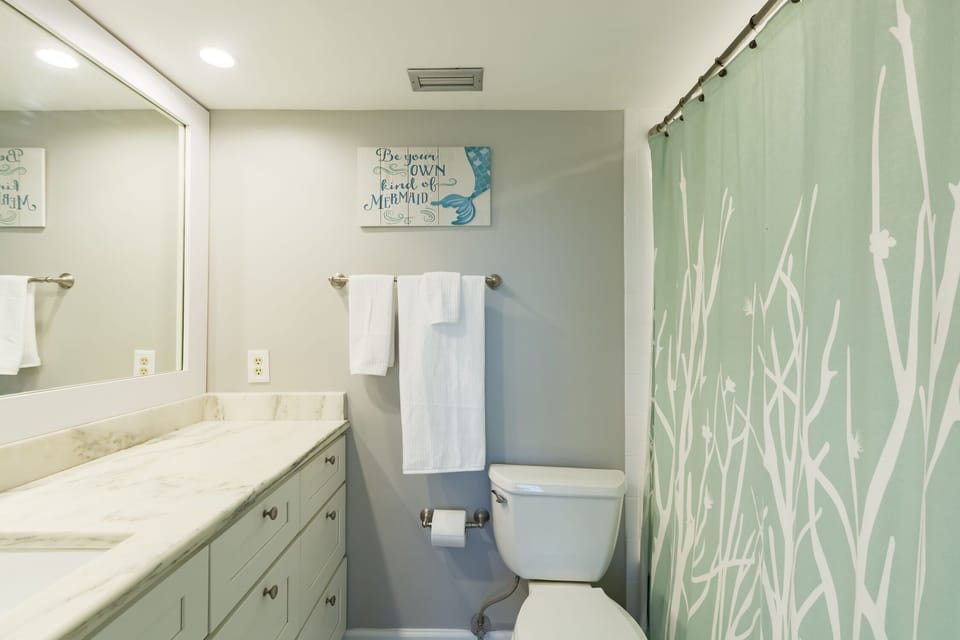 Master bathroom with large, quartz  countertop and plenty of drawers for storage