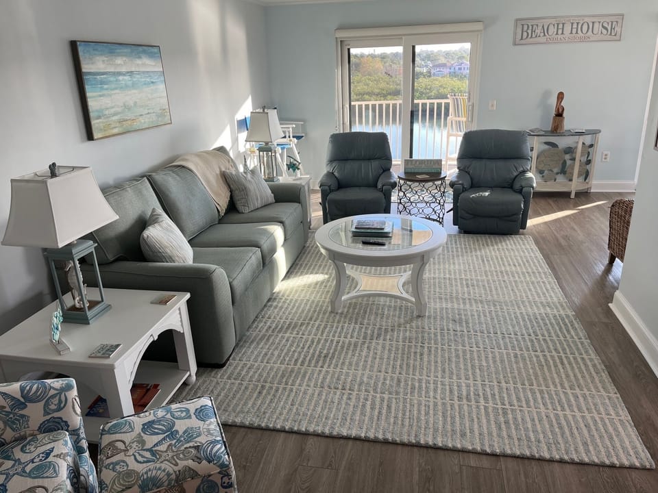 Coastal themed spacious living room adds to the relaxing vibe of Our Beach Home 