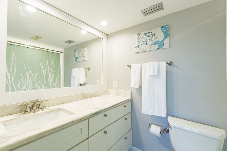 Master bathroom with beautiful quartz sink and a tub/shower combination.
