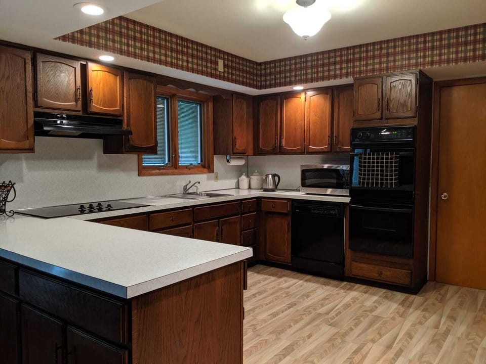 Open concept, stocked with cooking essentials, pots and dishes 
