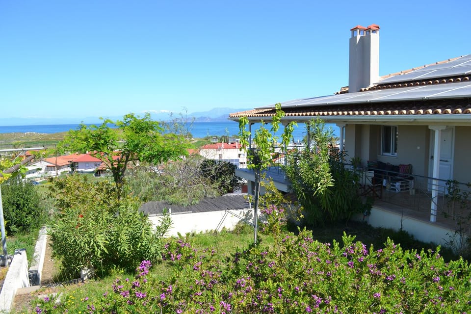 The house and the garden with the Corinthian Gulf in the background.